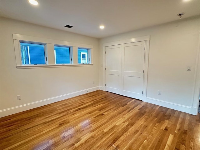 2 Wilkins Pl, Boston, MA 02131 - unfurnished bedroom with baseboards, wood finished floors, recessed lighting, and a closet