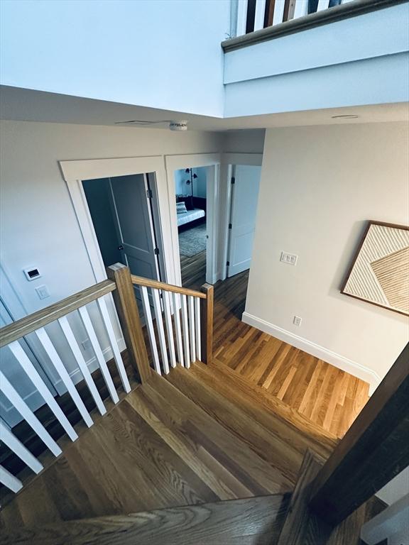 2 Wilkins Pl, Boston, MA 02131 - stairway featuring wood finished floors and baseboards