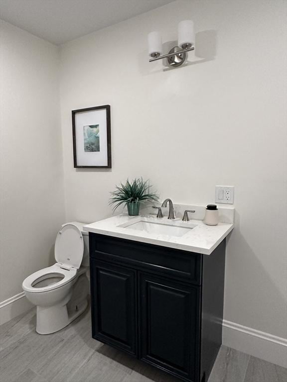 2 Wilkins Pl, Boston, MA 02131 - bathroom featuring baseboards, vanity, and toilet