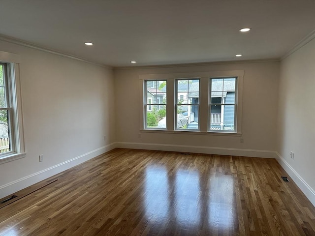 2 Wilkins Pl, Boston, MA 02131 - empty room featuring healthy amount of natural light, ornamental molding, wood finished floors, baseboards, and recessed lighting