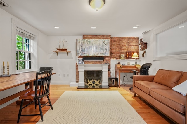 living room with a fireplace and light hardwood / wood-style flooring