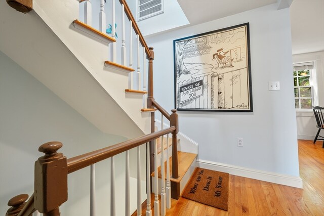 stairs featuring wood-type flooring