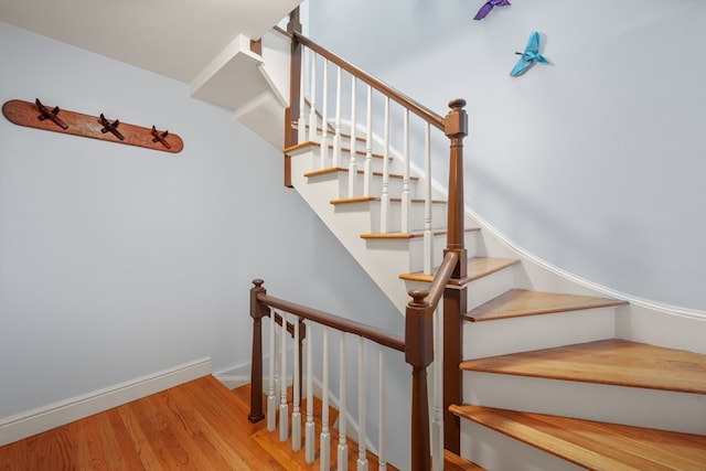 stairs featuring hardwood / wood-style flooring