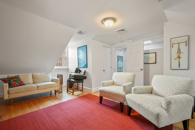 sitting room with lofted ceiling and hardwood / wood-style floors