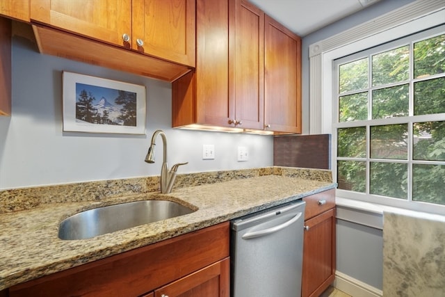 kitchen with dishwasher, sink, and light stone countertops