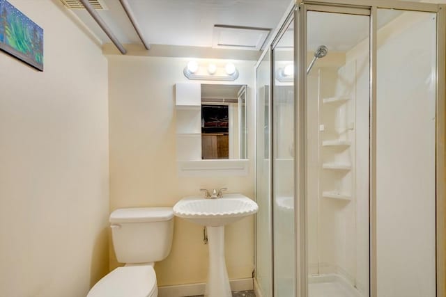 bathroom featuring toilet and an enclosed shower