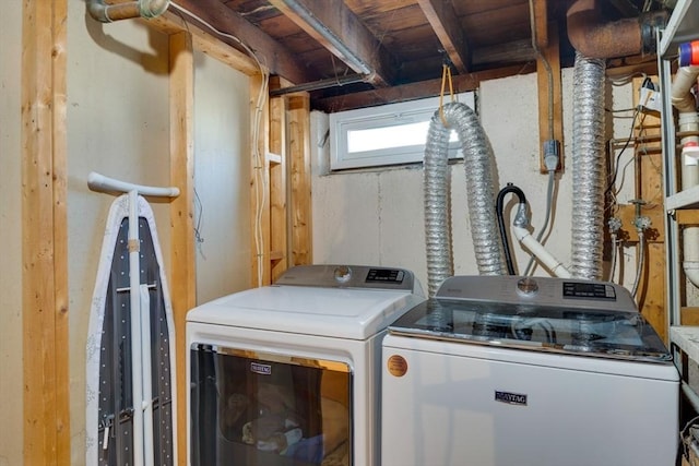 clothes washing area featuring washing machine and clothes dryer