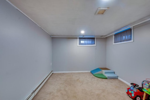 rec room with a baseboard radiator and light colored carpet