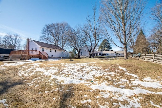 yard covered in snow featuring a wooden deck