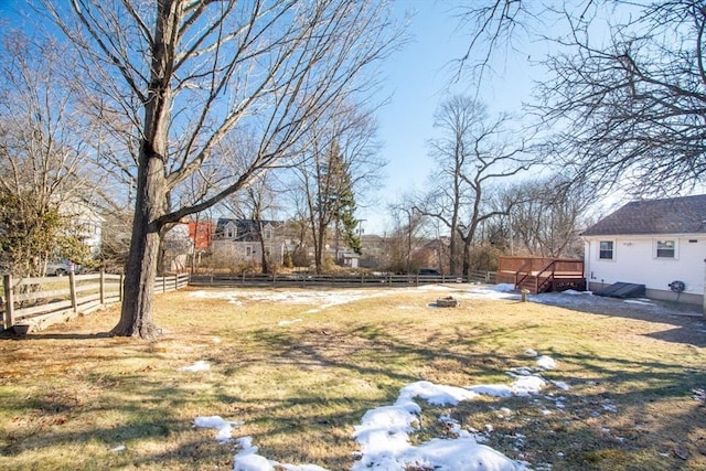 view of yard featuring a wooden deck and an outdoor fire pit