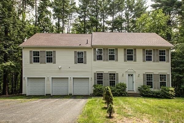 832 Westhampton Rd, Northampton, MA 01062 - colonial house with a garage, driveway, a front lawn, and view of scattered trees