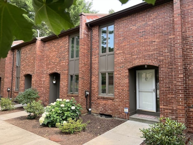 doorway to property with brick siding