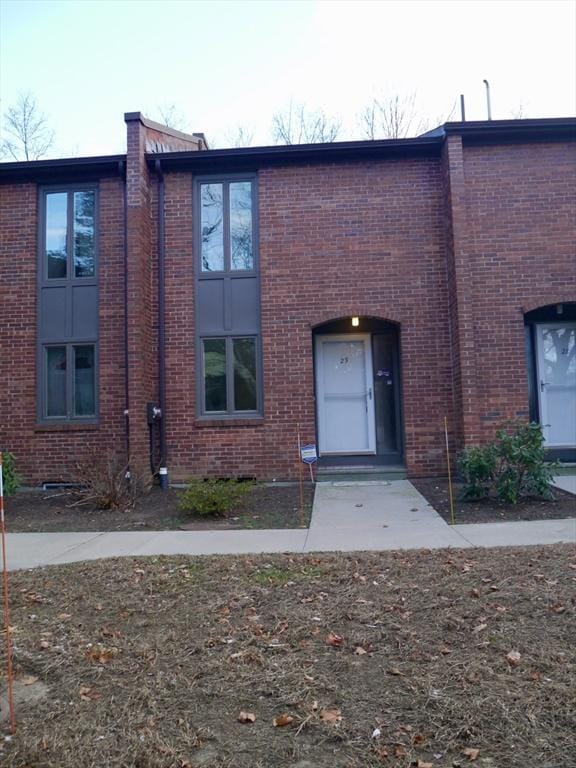 view of front of house featuring entry steps and brick siding