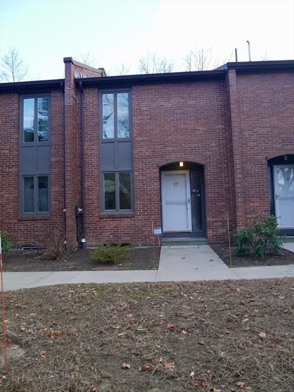 view of property with entry steps and brick siding