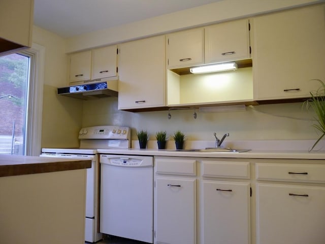 kitchen featuring light countertops, white appliances, a sink, and under cabinet range hood