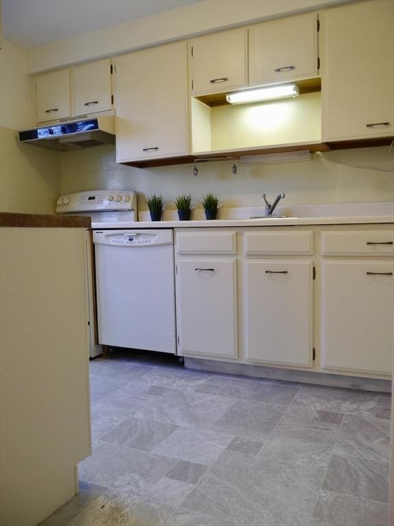 kitchen featuring range, dishwasher, light countertops, under cabinet range hood, and a sink