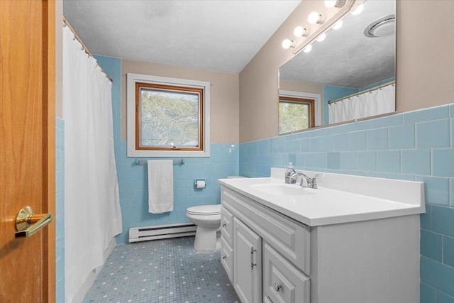 full bathroom featuring toilet, tile patterned flooring, vanity, a baseboard heating unit, and tile walls