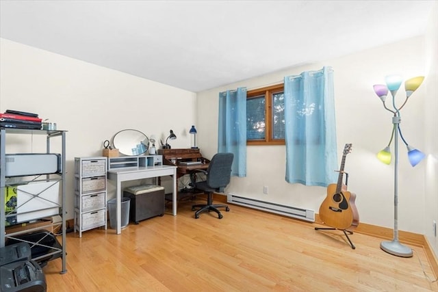 home office featuring baseboard heating and wood finished floors