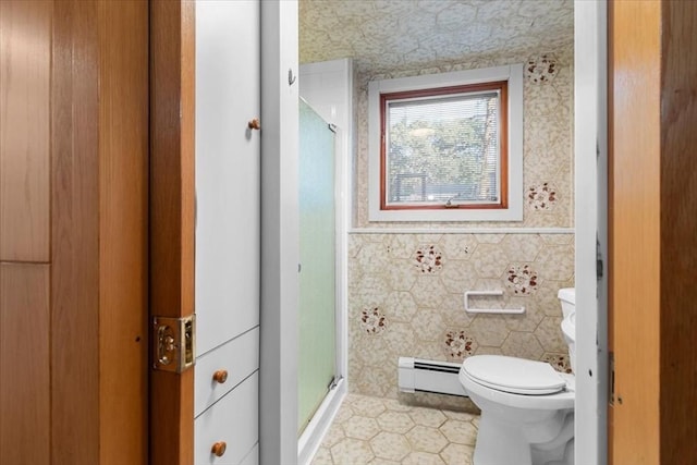 bathroom featuring toilet, a baseboard heating unit, tile walls, wainscoting, and a shower stall