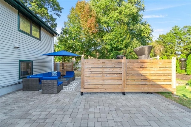 view of gate featuring a patio area and fence