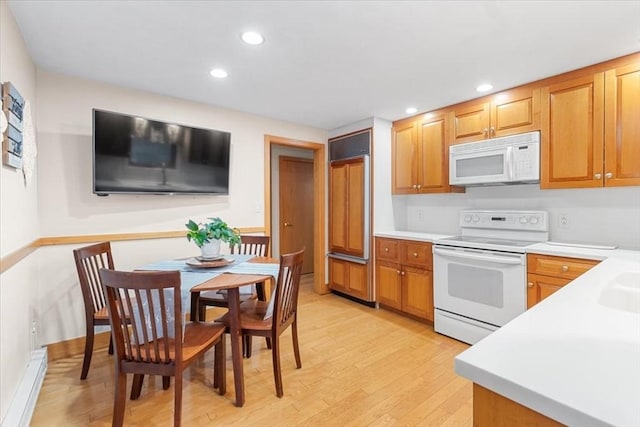 kitchen with recessed lighting, white appliances, light countertops, light wood-type flooring, and brown cabinets