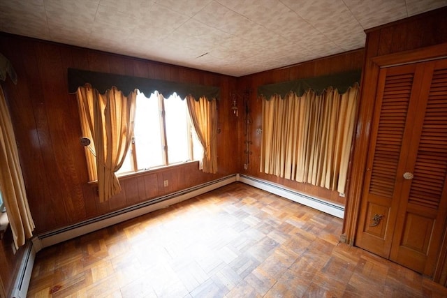102 Margin St, Salem, MA 01970 - spare room with wood walls and a baseboard heating unit