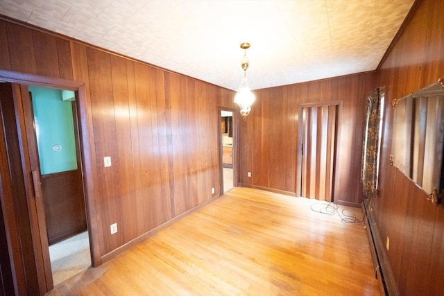 102 Margin St, Salem, MA 01970 - spare room with light wood finished floors, wooden walls, and baseboards