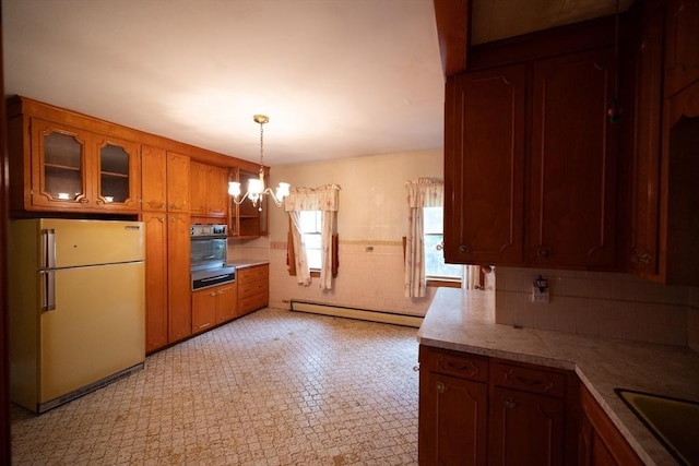 102 Margin St, Salem, MA 01970 - kitchen featuring freestanding refrigerator, a baseboard radiator, a warming drawer, a chandelier, and brown cabinetry
