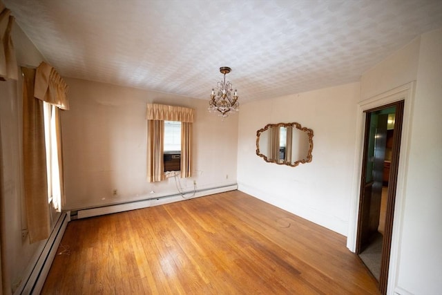 102 Margin St, Salem, MA 01970 - empty room featuring a baseboard heating unit, a chandelier, light wood finished floors, and baseboards