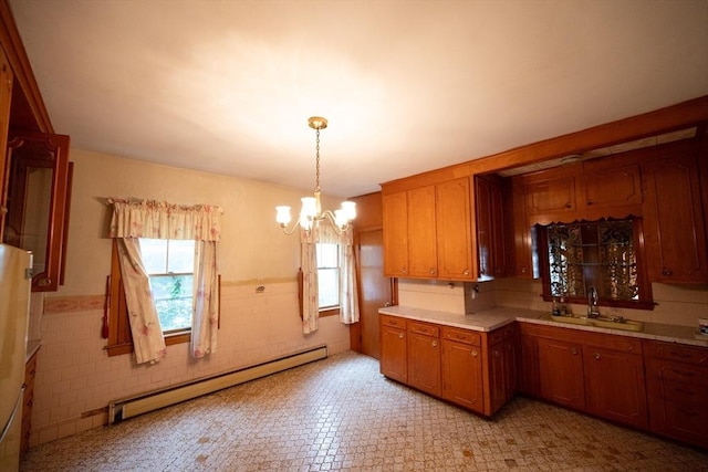 102 Margin St, Salem, MA 01970 - kitchen featuring a baseboard heating unit, a sink, a chandelier, light countertops, and brown cabinets