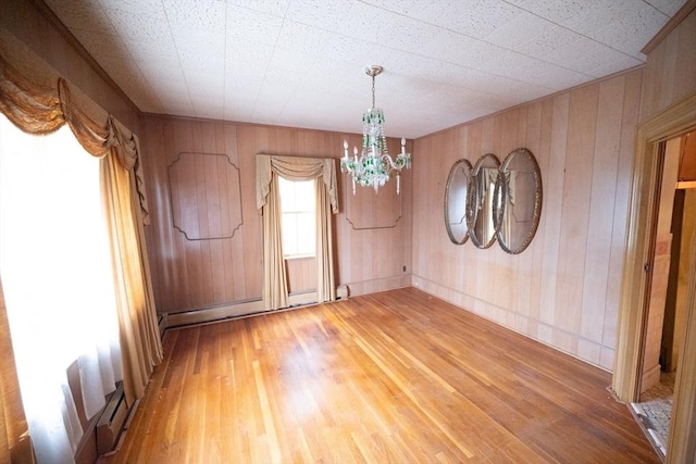 102 Margin St, Salem, MA 01970 - unfurnished dining area featuring light wood-style flooring, a chandelier, and wood walls