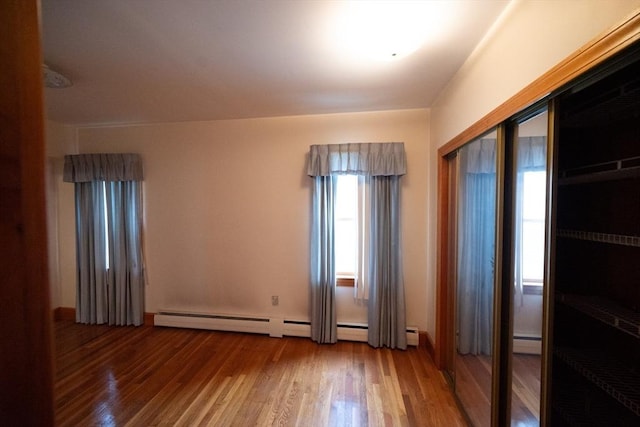 102 Margin St, Salem, MA 01970 - empty room featuring wood finished floors and a baseboard heating unit