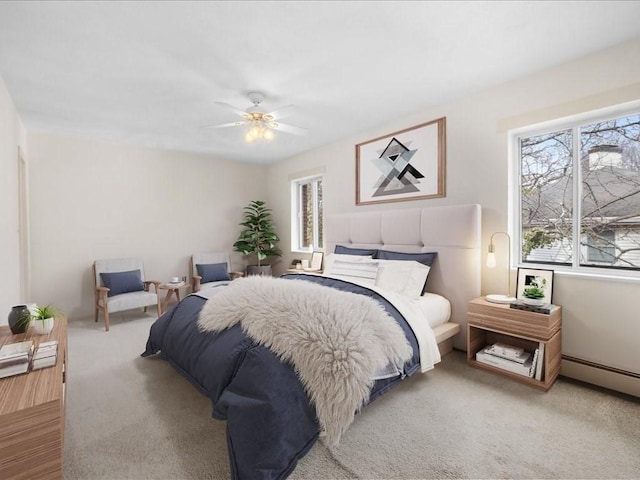 bedroom with ceiling fan, a baseboard radiator, and carpet flooring