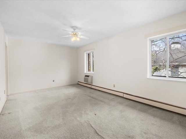 unfurnished room with a baseboard heating unit, ceiling fan, carpet flooring, and baseboards