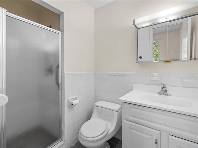 bathroom with toilet, a shower stall, and vanity