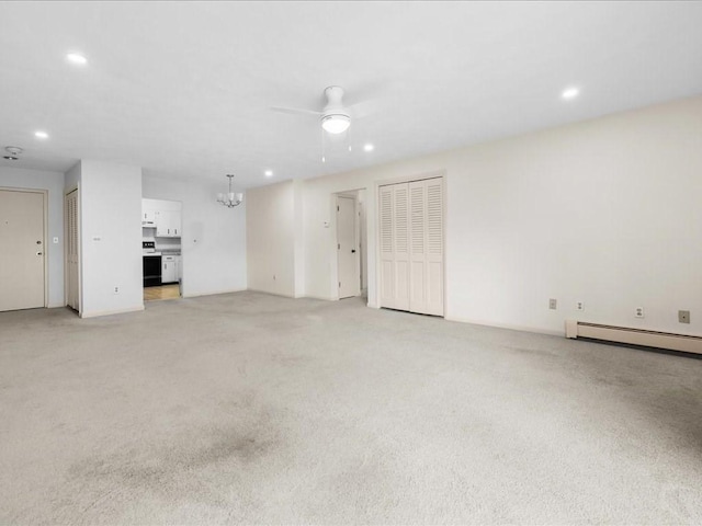 unfurnished living room with light carpet, recessed lighting, baseboard heating, and ceiling fan with notable chandelier