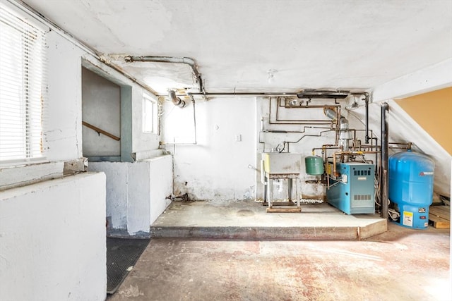 utility room featuring a heating unit and a sink