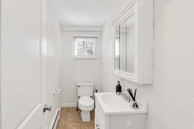 bathroom featuring tile patterned flooring, toilet, a baseboard heating unit, vanity, and baseboards