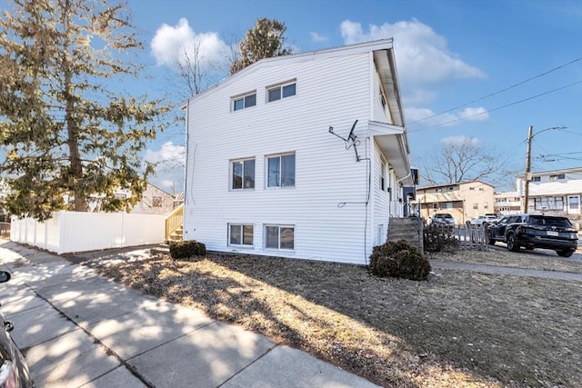 rear view of house with fence