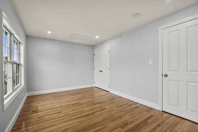 spare room with hardwood / wood-style flooring and a wealth of natural light