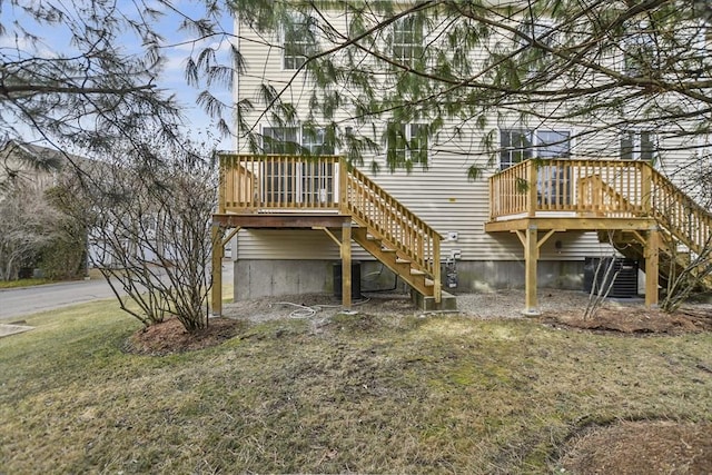 rear view of property with a wooden deck and a yard