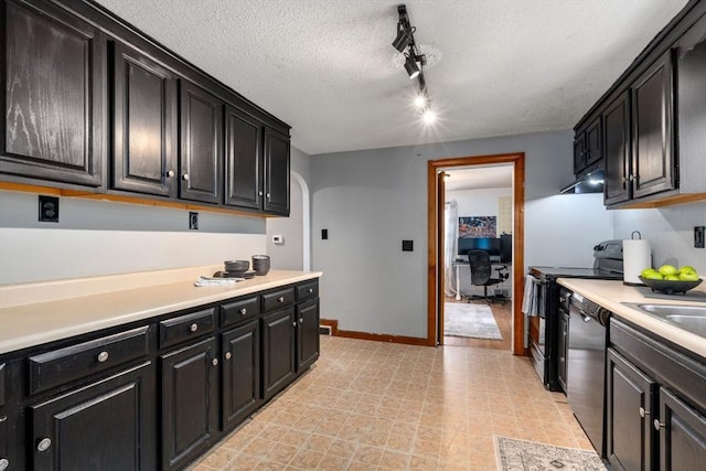 kitchen with arched walkways, dark cabinets, under cabinet range hood, light countertops, and black appliances