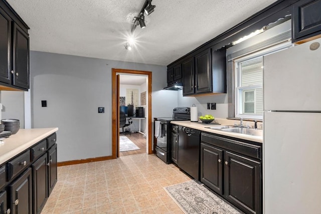 kitchen with under cabinet range hood, light countertops, a textured ceiling, black appliances, and a sink