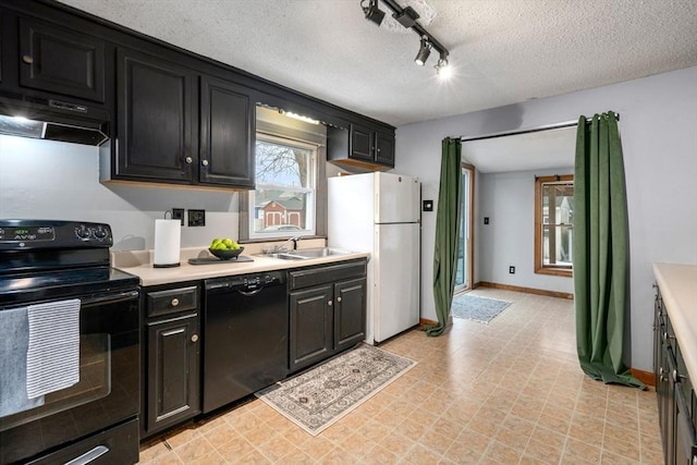 kitchen featuring black appliances, dark cabinets, light countertops, and under cabinet range hood