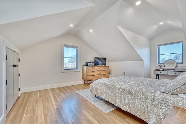 bedroom with baseboards, light wood-type flooring, multiple windows, and lofted ceiling