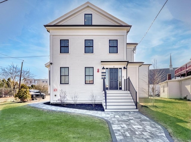 greek revival inspired property featuring a front yard