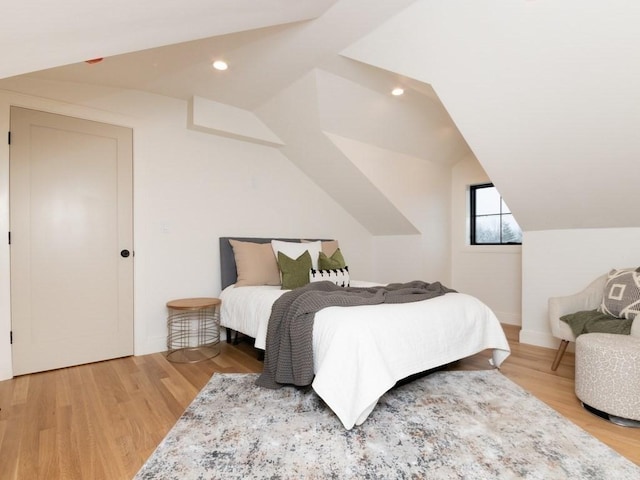 bedroom with lofted ceiling, light wood-style flooring, and recessed lighting