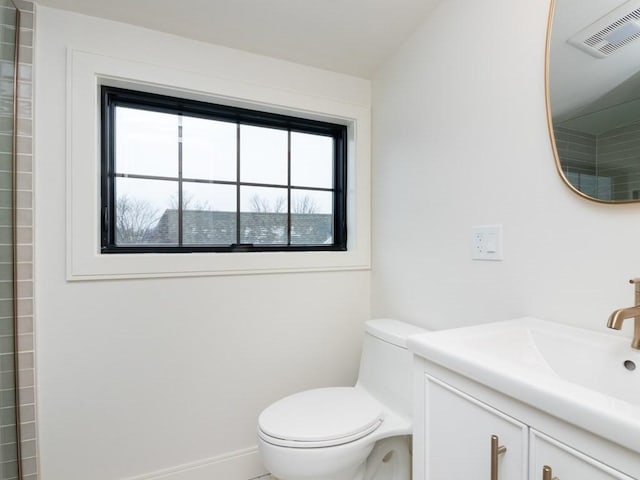 bathroom featuring vanity, toilet, baseboards, and visible vents