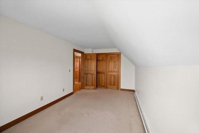 bonus room featuring baseboards, vaulted ceiling, baseboard heating, and light colored carpet