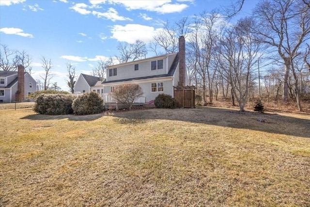 view of front of property featuring a chimney and a front yard